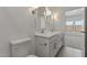 Bathroom with double vanity, modern lighting, and neutral walls at 3913 S 233Rd Ln, Buckeye, AZ 85326