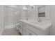 Modern bathroom featuring a double sink vanity, walk-in shower with glass door, and neutral color palette at 3913 S 233Rd Ln, Buckeye, AZ 85326