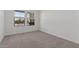 Bright bedroom featuring neutral carpet, white walls, and a window view at 3913 S 233Rd Ln, Buckeye, AZ 85326
