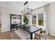 Inviting dining room with modern lighting and a view to the outdoors at 3913 S 233Rd Ln, Buckeye, AZ 85326