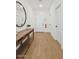 Bright hallway with wood floors and a console table under a decorative mirror at 3913 S 233Rd Ln, Buckeye, AZ 85326