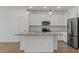 White kitchen featuring an island, white cabinetry, and stainless steel appliances at 3913 S 233Rd Ln, Buckeye, AZ 85326