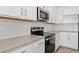 Modern kitchen featuring white cabinets, stainless steel appliances, and light countertops at 3913 S 233Rd Ln, Buckeye, AZ 85326