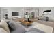Comfortable living area with modern decor, a stylish coffee table, and an open layout at 3913 S 233Rd Ln, Buckeye, AZ 85326