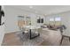 Open-concept space combining dining and living areas, with modern decor and plenty of natural light at 3913 S 233Rd Ln, Buckeye, AZ 85326