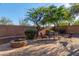 Private backyard with a brick patio, fire pit, and comfortable seating area, ideal for outdoor relaxation at 41638 N Emerald Lake Dr, Anthem, AZ 85086
