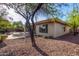 Well-maintained backyard with a stone patio, fire pit, and desert landscaping at 41638 N Emerald Lake Dr, Anthem, AZ 85086