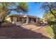 Charming backyard with a stone patio, cozy seating, and mature landscaping, perfect for outdoor living at 41638 N Emerald Lake Dr, Anthem, AZ 85086
