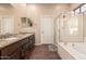 Bathroom features double sinks, granite counters, walk-in shower, and soaking tub at 41638 N Emerald Lake Dr, Anthem, AZ 85086