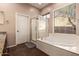 Bright bathroom featuring a shower, separate soaking tub, and a window for natural light at 41638 N Emerald Lake Dr, Anthem, AZ 85086