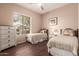 Cozy bedroom featuring two twin beds, dresser, and a large window for natural light at 41638 N Emerald Lake Dr, Anthem, AZ 85086