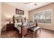 Cozy bedroom featuring a decorative wrought iron bed frame, hardwood floors, and large window at 41638 N Emerald Lake Dr, Anthem, AZ 85086