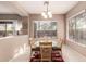 Bright dining area with a glass table, comfortable chairs, and a large window overlooking the outdoors at 41638 N Emerald Lake Dr, Anthem, AZ 85086