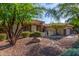 Attractive single-story home with desert landscaping, mature trees, and a welcoming entrance at 41638 N Emerald Lake Dr, Anthem, AZ 85086