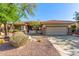 Inviting front exterior featuring desert landscaping and a two-car garage at 41638 N Emerald Lake Dr, Anthem, AZ 85086