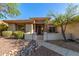 Charming home exterior featuring a well-maintained front yard with desert landscaping and mature trees at 41638 N Emerald Lake Dr, Anthem, AZ 85086