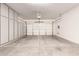 A spacious two-car garage, featuring painted floors and built in storage cabinets along the side wall at 41638 N Emerald Lake Dr, Anthem, AZ 85086