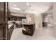 Bright kitchen featuring a large island, dark wood cabinets, and modern stainless steel appliances at 41638 N Emerald Lake Dr, Anthem, AZ 85086