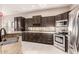 Kitchen showcasing granite counters, stainless steel appliances, and dark wood cabinetry at 41638 N Emerald Lake Dr, Anthem, AZ 85086