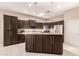 Spacious kitchen with dark wood cabinets, granite countertops, and stainless steel appliances at 41638 N Emerald Lake Dr, Anthem, AZ 85086