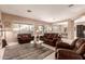 Comfortable living room with plush seating, a neutral color palette, and views to outdoor patio at 41638 N Emerald Lake Dr, Anthem, AZ 85086