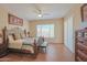 A cozy bedroom featuring a decorative wrought-iron bed frame and hardwood floors at 41638 N Emerald Lake Dr, Anthem, AZ 85086