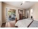 Bedroom with sliding glass doors leading to the patio, allowing for ample natural light at 41638 N Emerald Lake Dr, Anthem, AZ 85086