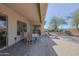 Covered patio area with seating and views of the private backyard and desert landscaping at 41638 N Emerald Lake Dr, Anthem, AZ 85086
