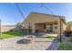 Charming backyard with a cozy fire pit, artificial lawn, and ample space for relaxation at 4514 W Hazel Ln, San Tan Valley, AZ 85144
