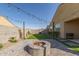 Landscaped backyard featuring a stone fire pit, manicured lawn, and ambient string lights at 4514 W Hazel Ln, San Tan Valley, AZ 85144