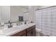 Bathroom with double sinks, white countertop, and updated fixtures at 4514 W Hazel Ln, San Tan Valley, AZ 85144