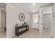 Inviting entryway with neutral walls, tile flooring, and decorative table with a wagon wheel decor at 4514 W Hazel Ln, San Tan Valley, AZ 85144