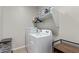 Well-equipped laundry room featuring a washer, dryer, and ample shelving for storage at 4514 W Hazel Ln, San Tan Valley, AZ 85144