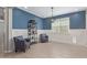 Bright living room features wainscotting, modern light fixture, and comfortable seating at 4514 W Hazel Ln, San Tan Valley, AZ 85144