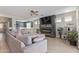 Inviting living room features a sleek fireplace, large sectional, and seamless flow into dining at 4514 W Hazel Ln, San Tan Valley, AZ 85144