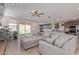 Spacious living room with a large gray sofa, access to backyard and open floor plan at 4514 W Hazel Ln, San Tan Valley, AZ 85144