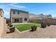 Back yard featuring grass, decorative rocks, block fence, and patio at 4527 E Gagarinite Ln, San Tan Valley, AZ 85143