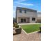 Backyard featuring low-maintenance landscaping, a well-manicured lawn, and a sliding glass door for seamless indoor-outdoor living at 4527 E Gagarinite Ln, San Tan Valley, AZ 85143