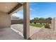 Covered patio area and backyard featuring artificial grass, paver patio, and desert landscaping at 4527 E Gagarinite Ln, San Tan Valley, AZ 85143