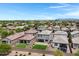 Aerial view of backyards featuring pavers, artificial turf, landscaping, trampoline, and privacy fence at 4527 E Gagarinite Ln, San Tan Valley, AZ 85143