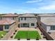 Aerial view of a backyard featuring pavers, artificial turf, landscaping, and privacy fence at 4527 E Gagarinite Ln, San Tan Valley, AZ 85143