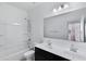 Bathroom featuring double sinks, a shower-tub combo, and modern lighting at 4527 E Gagarinite Ln, San Tan Valley, AZ 85143