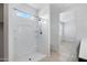 Bathroom featuring a walk-in shower with blue sky views, and a tile floor at 4527 E Gagarinite Ln, San Tan Valley, AZ 85143