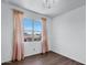 Bright bedroom with hardwood floors, a large window with neighborhood views and stylish curtains at 4527 E Gagarinite Ln, San Tan Valley, AZ 85143