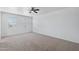 Spacious bedroom features two bright windows, a ceiling fan, and neutral carpet at 4527 E Gagarinite Ln, San Tan Valley, AZ 85143