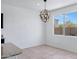 Bright dining area featuring a modern chandelier and large window overlooking the backyard at 4527 E Gagarinite Ln, San Tan Valley, AZ 85143