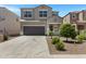 Inviting two-story home boasting a wide driveway, attached two-car garage, and desert landscaping at 4527 E Gagarinite Ln, San Tan Valley, AZ 85143