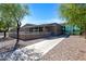 Modern building featuring a stone facade, a walkway, a covered entrance, and large windows offering ample natural light at 4527 E Gagarinite Ln, San Tan Valley, AZ 85143