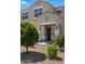 Inviting home entrance with a covered porch, desert landscaping, and a stylish front door, creating curb appeal at 4527 E Gagarinite Ln, San Tan Valley, AZ 85143