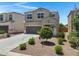 Attractive two-story home with desert landscaping, a two-car garage, and a charming front porch at 4527 E Gagarinite Ln, San Tan Valley, AZ 85143